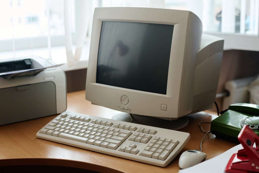 Old computer on desk representing obsolete hardware and IT risk